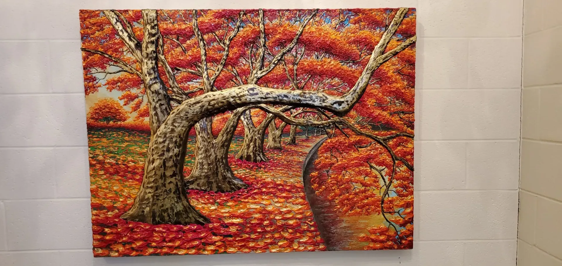 Painting of an autumn forest with orange and red foliage. Trees with textured bark are in the foreground.