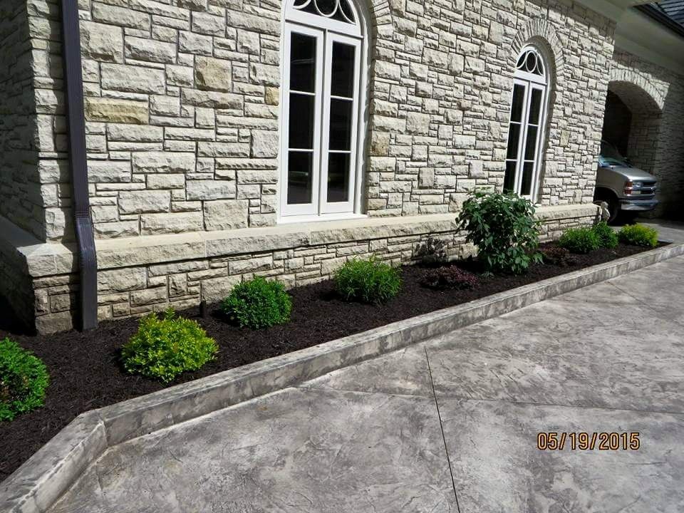 A stone house with a car parked in front of it