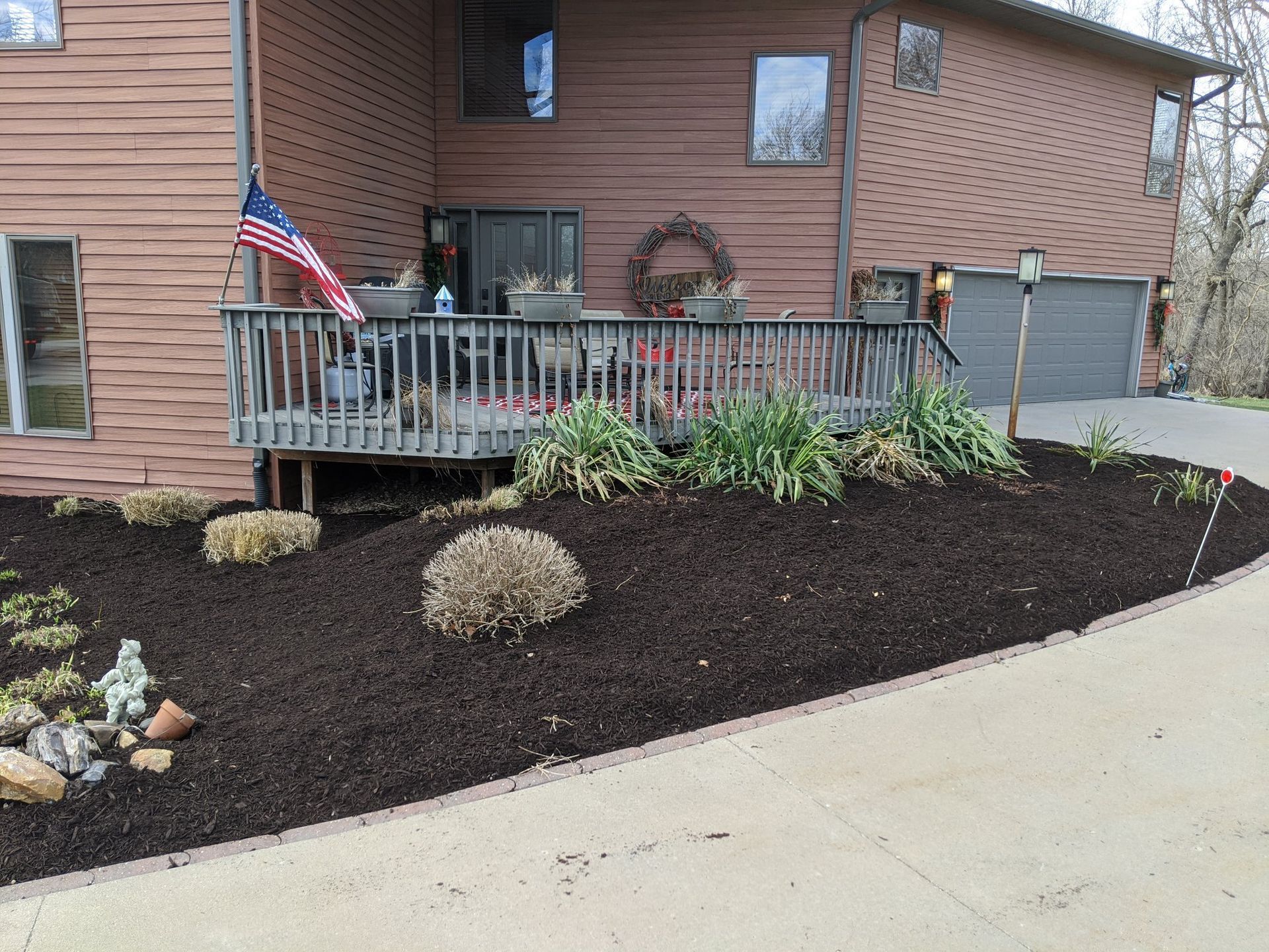 A house with a deck and a flag in front of it.