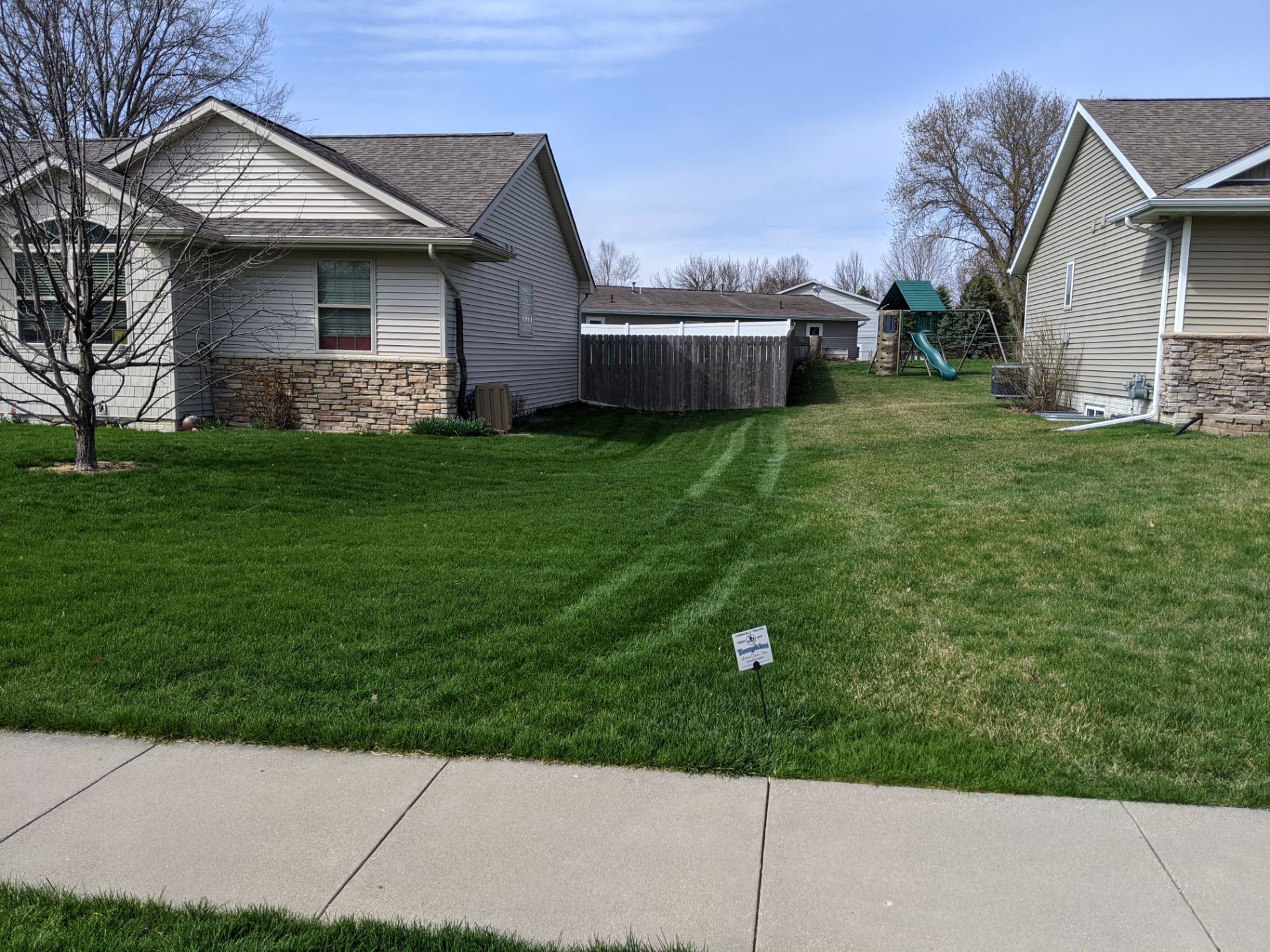 A house with a large lawn in front of it