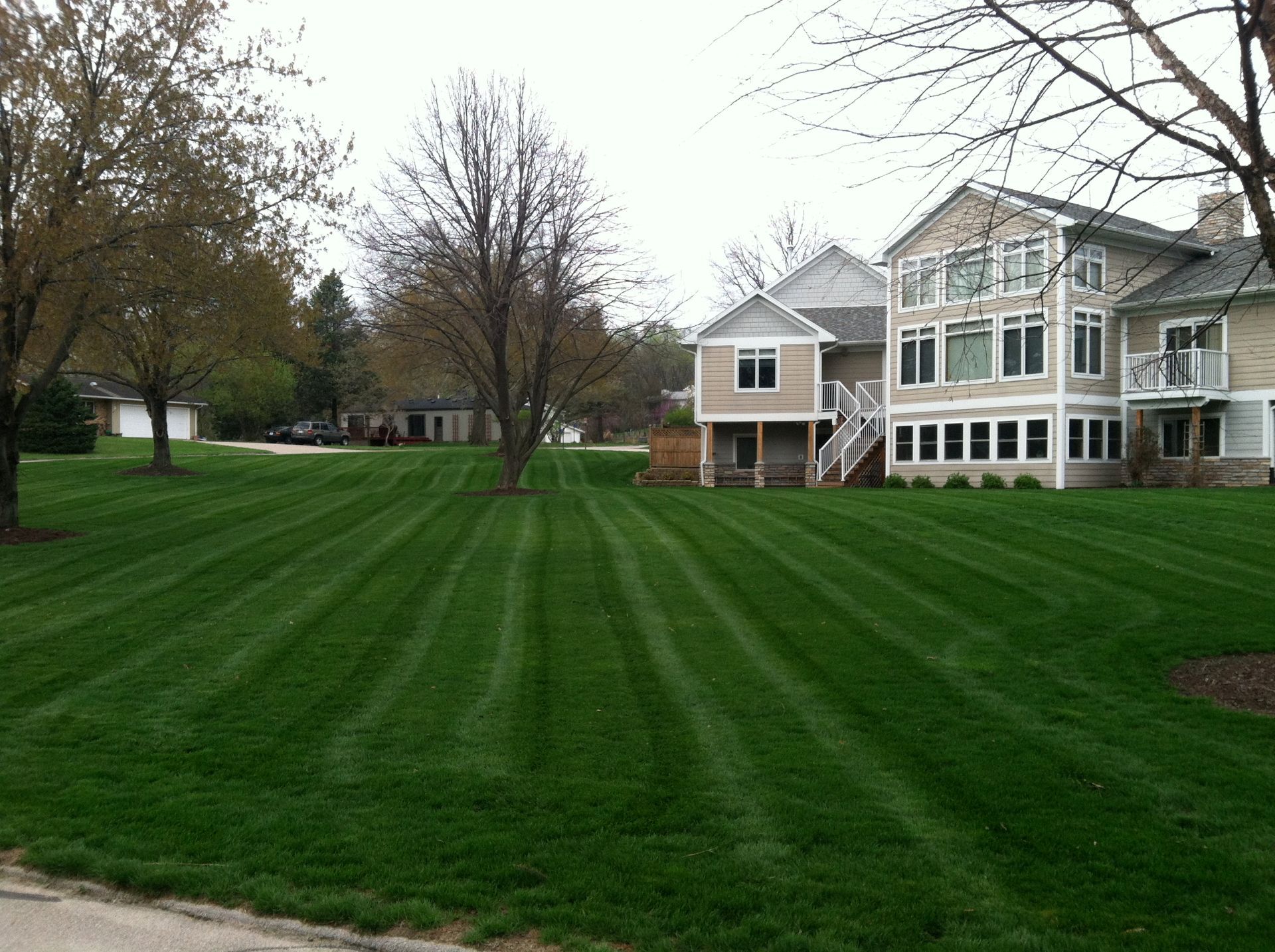 A large house with a lush green lawn in front of it