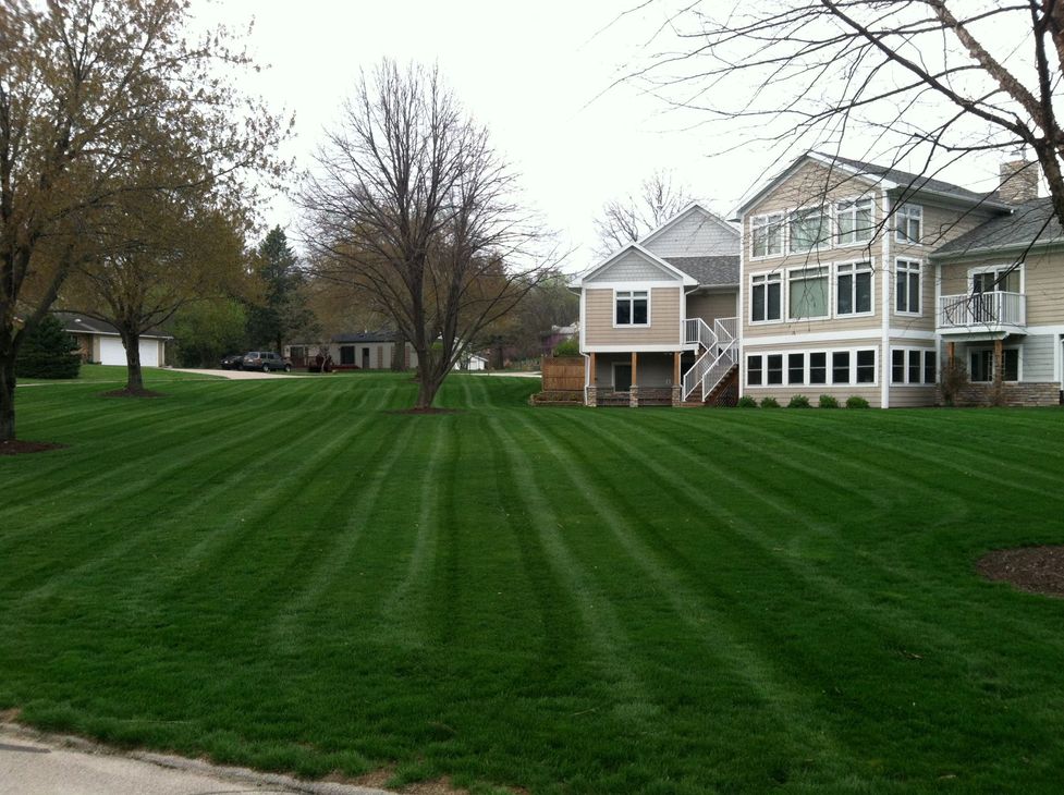 A large house with a lush green lawn in front of it