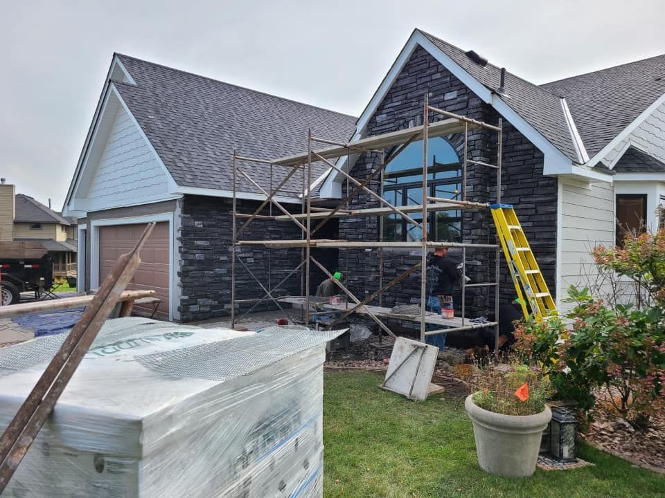 A house is being remodeled with scaffolding in front of it.