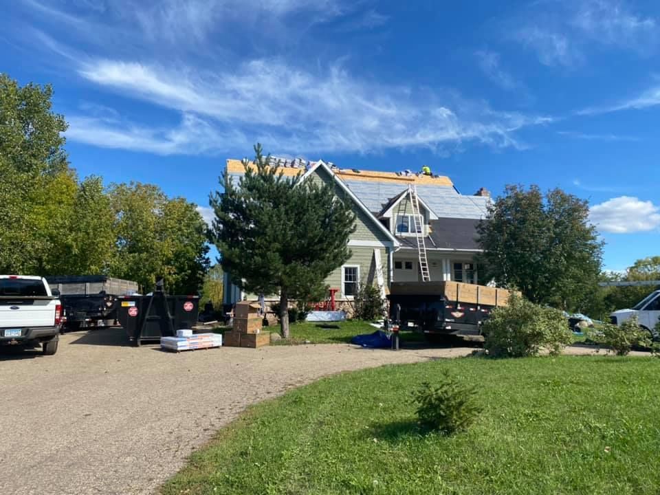 A large house is being remodeled with a new roof.