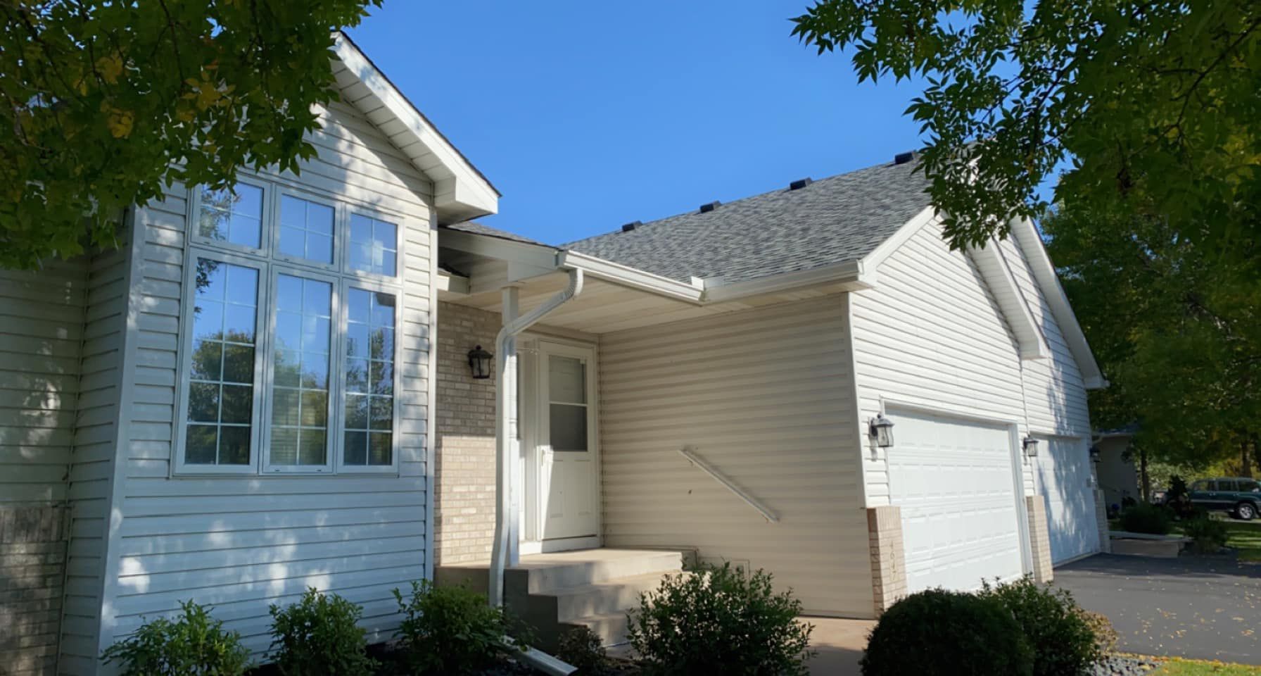 A white house with a blue sky in the background