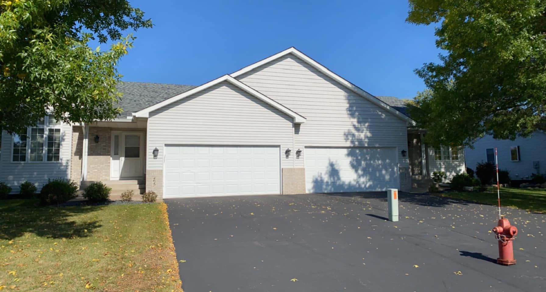 A large white house with a fire hydrant in front of it.