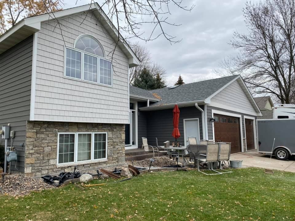 A house with a trailer parked in front of it.
