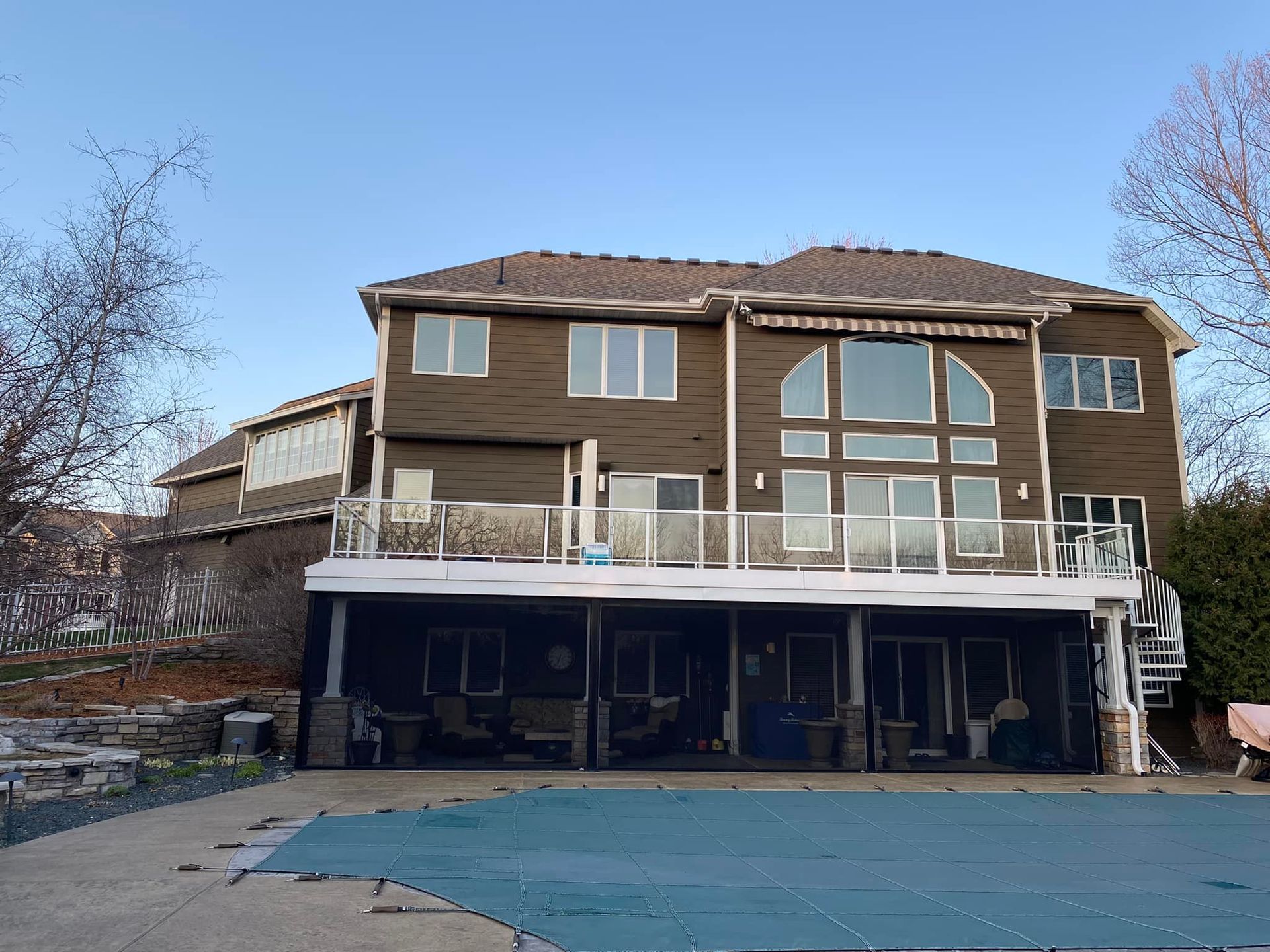 A large house with a swimming pool in front of it.