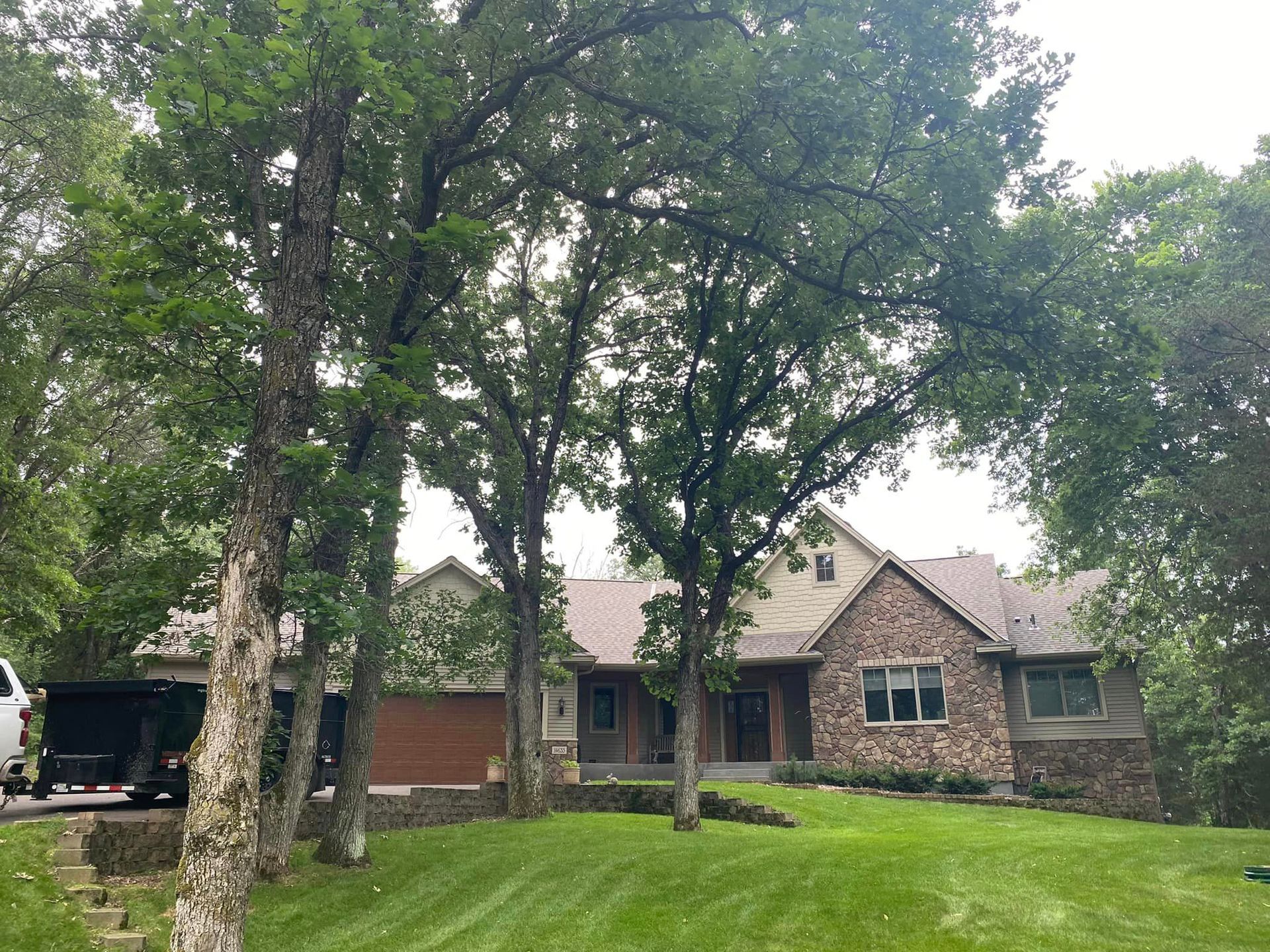 A large house with a lot of trees in front of it.