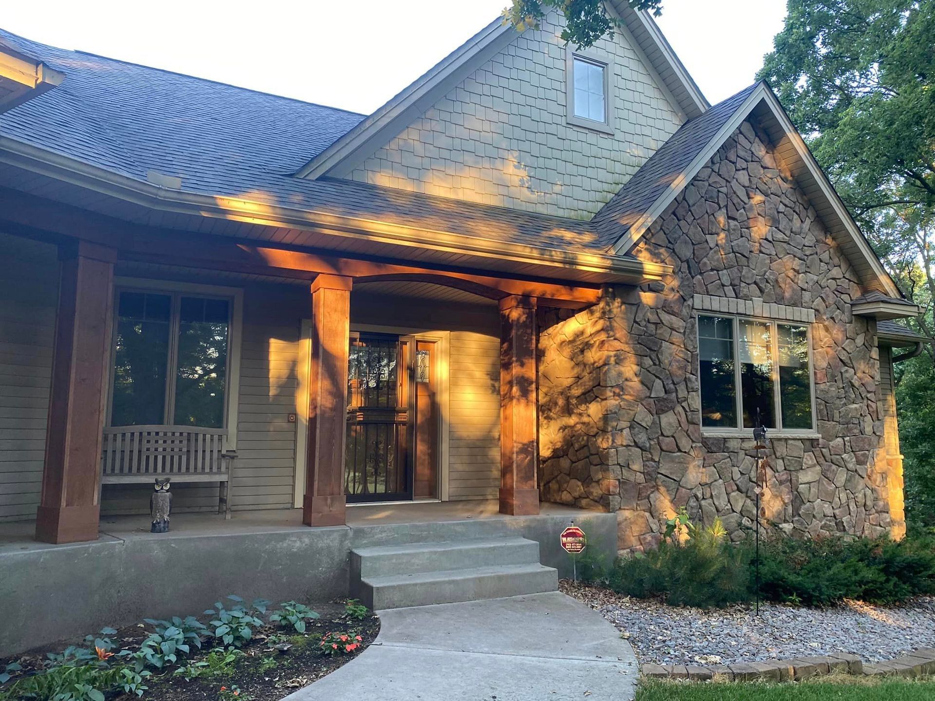A house with a porch and a bench in front of it