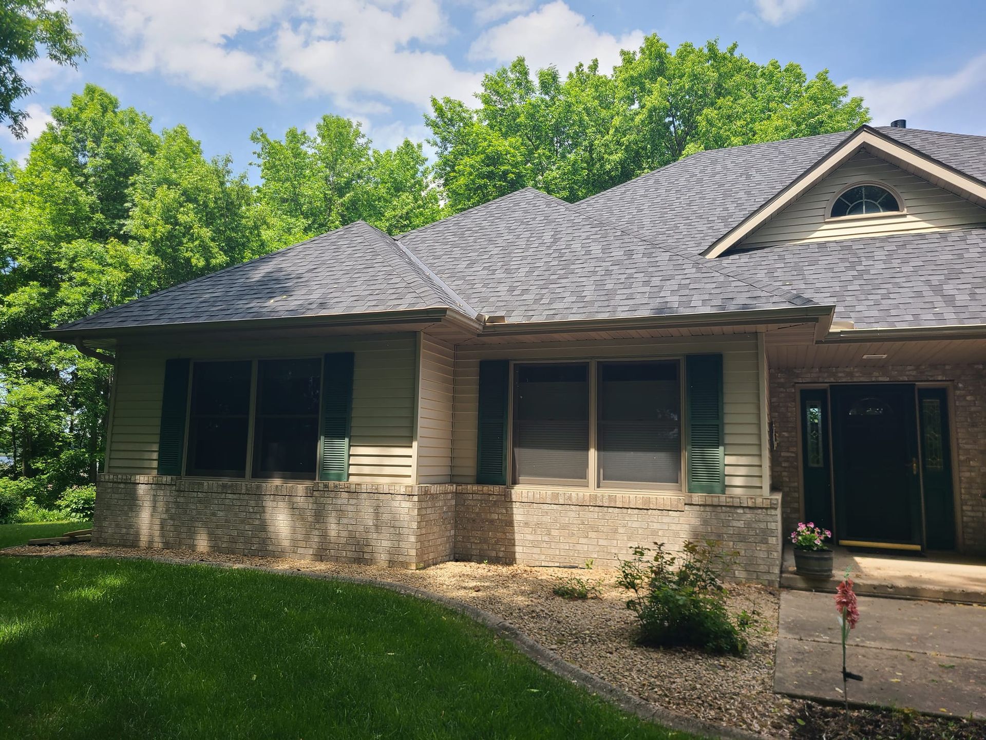A house with a gray roof and a lot of windows