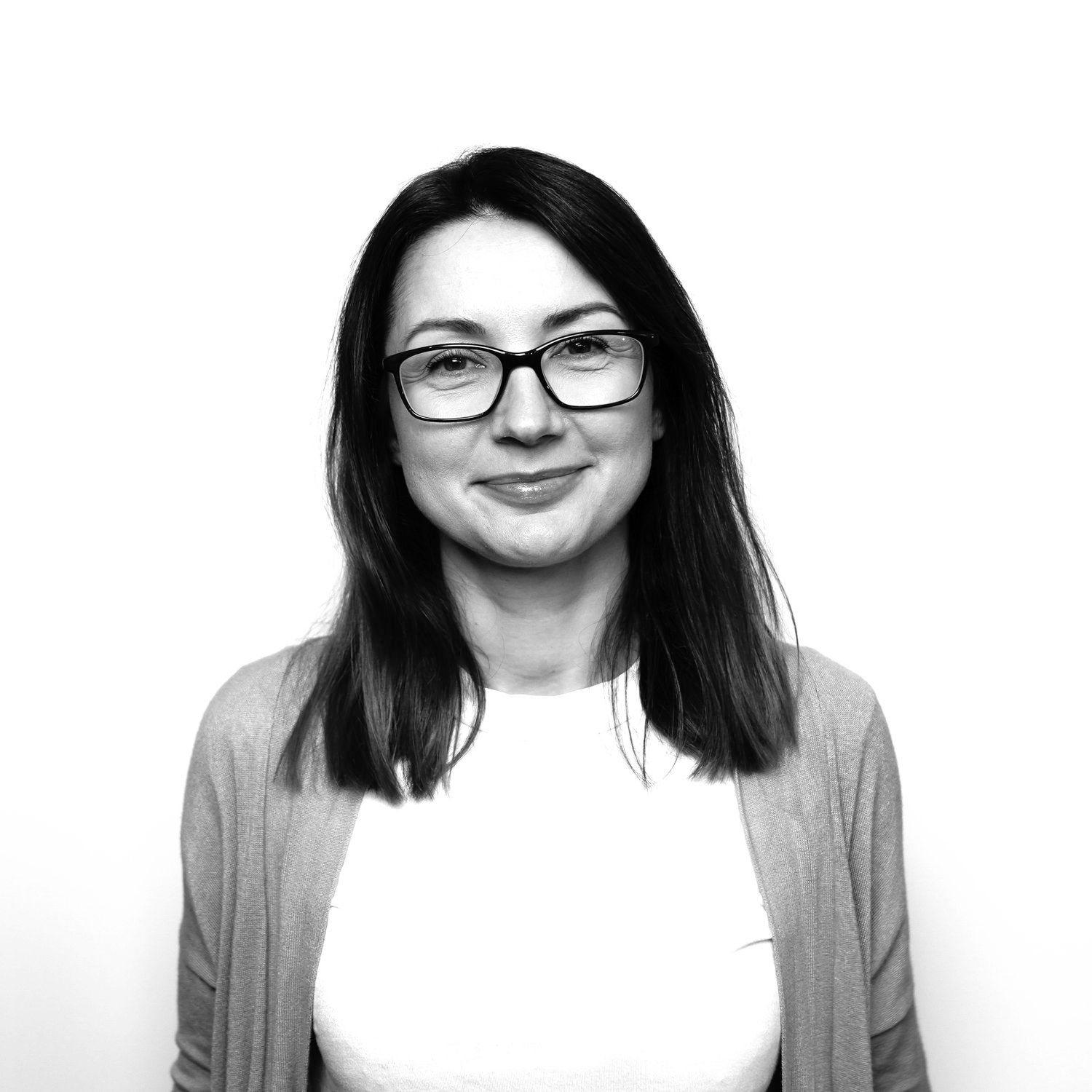 A black and white photo of a bald man with a beard looking at the camera.