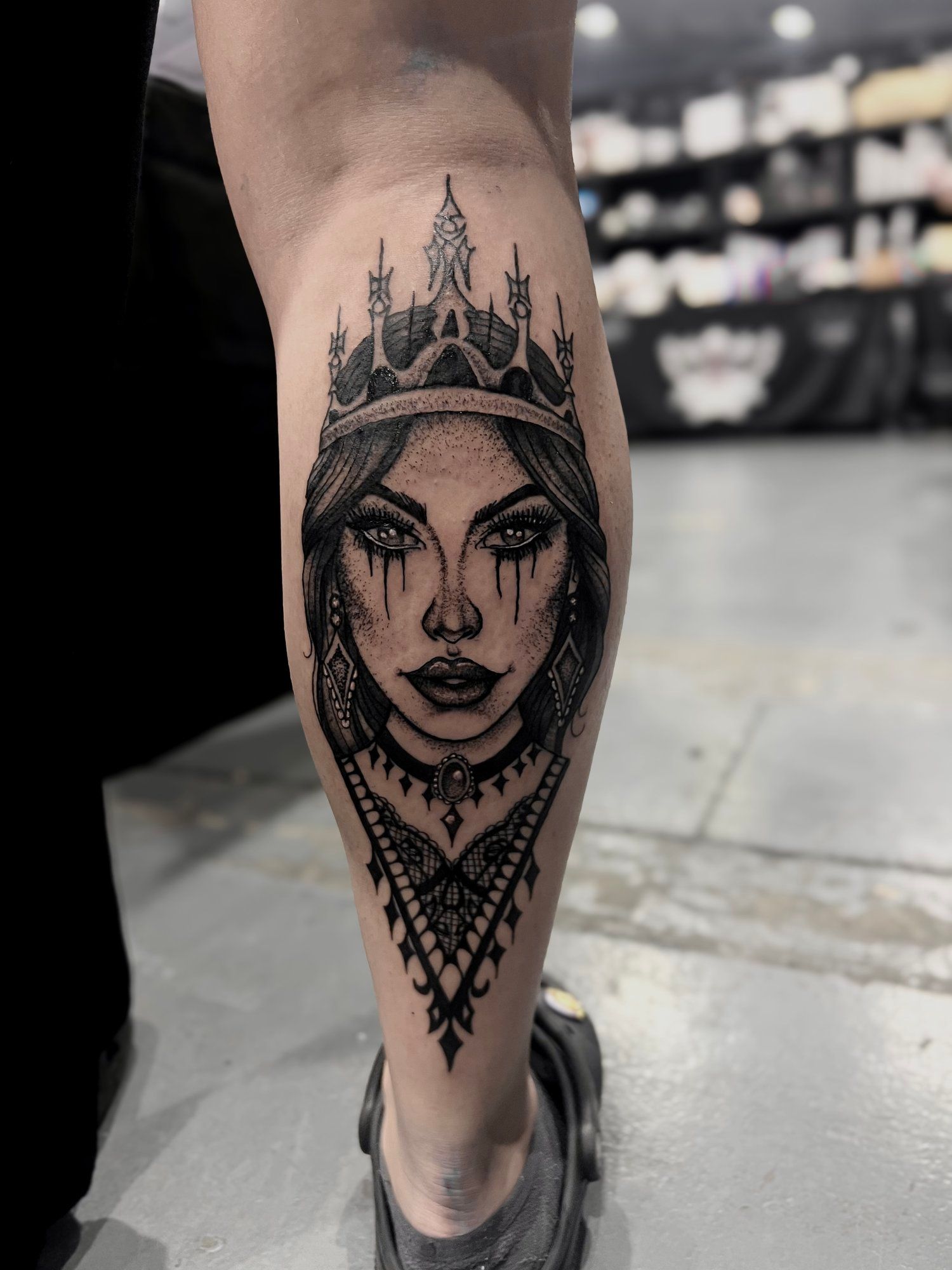 A tattoo of a woman with a crown on her head