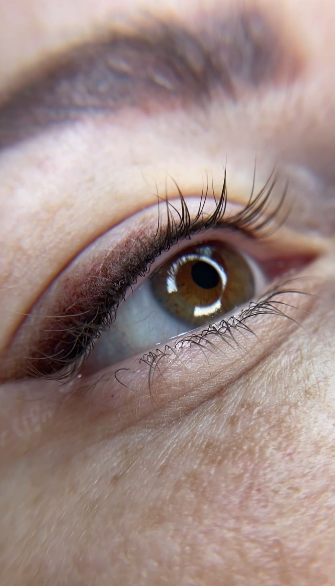 A close up of a woman 's eye with makeup on it.