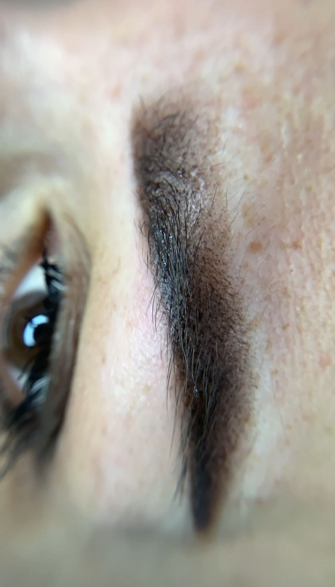 A close up of a woman 's eye with makeup on.
