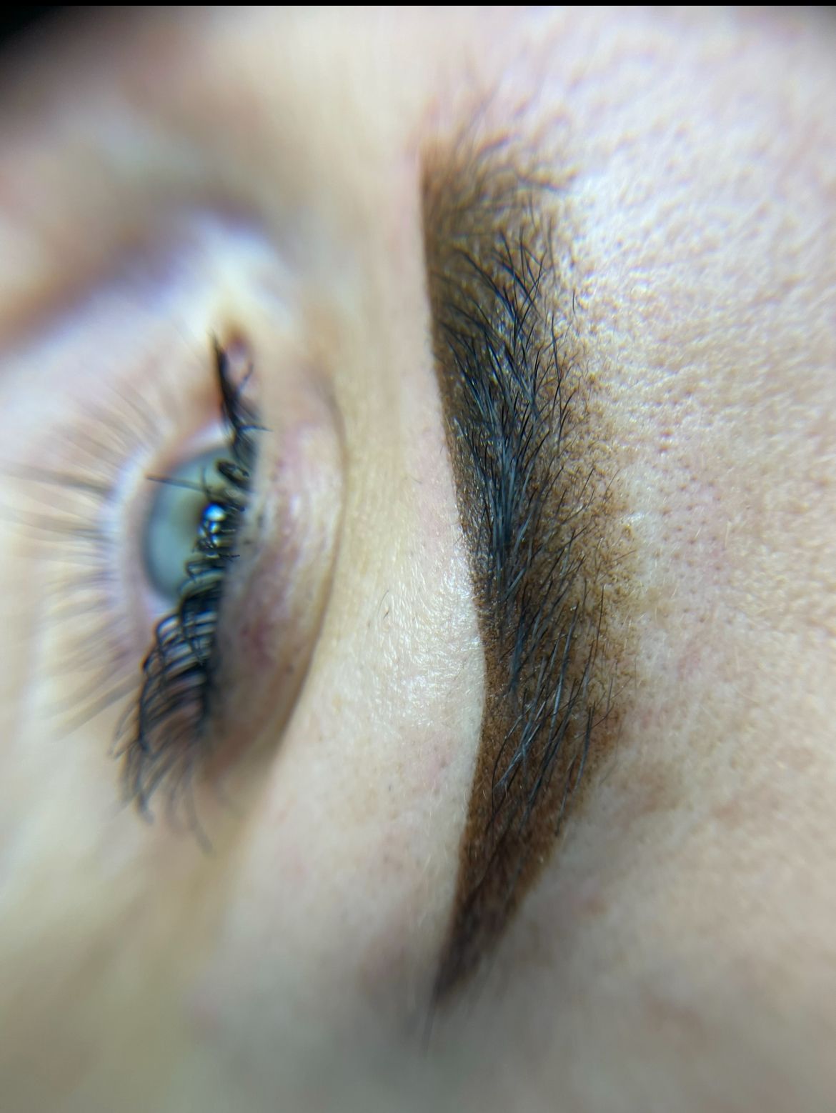A close up of a woman 's eye and eyebrows.