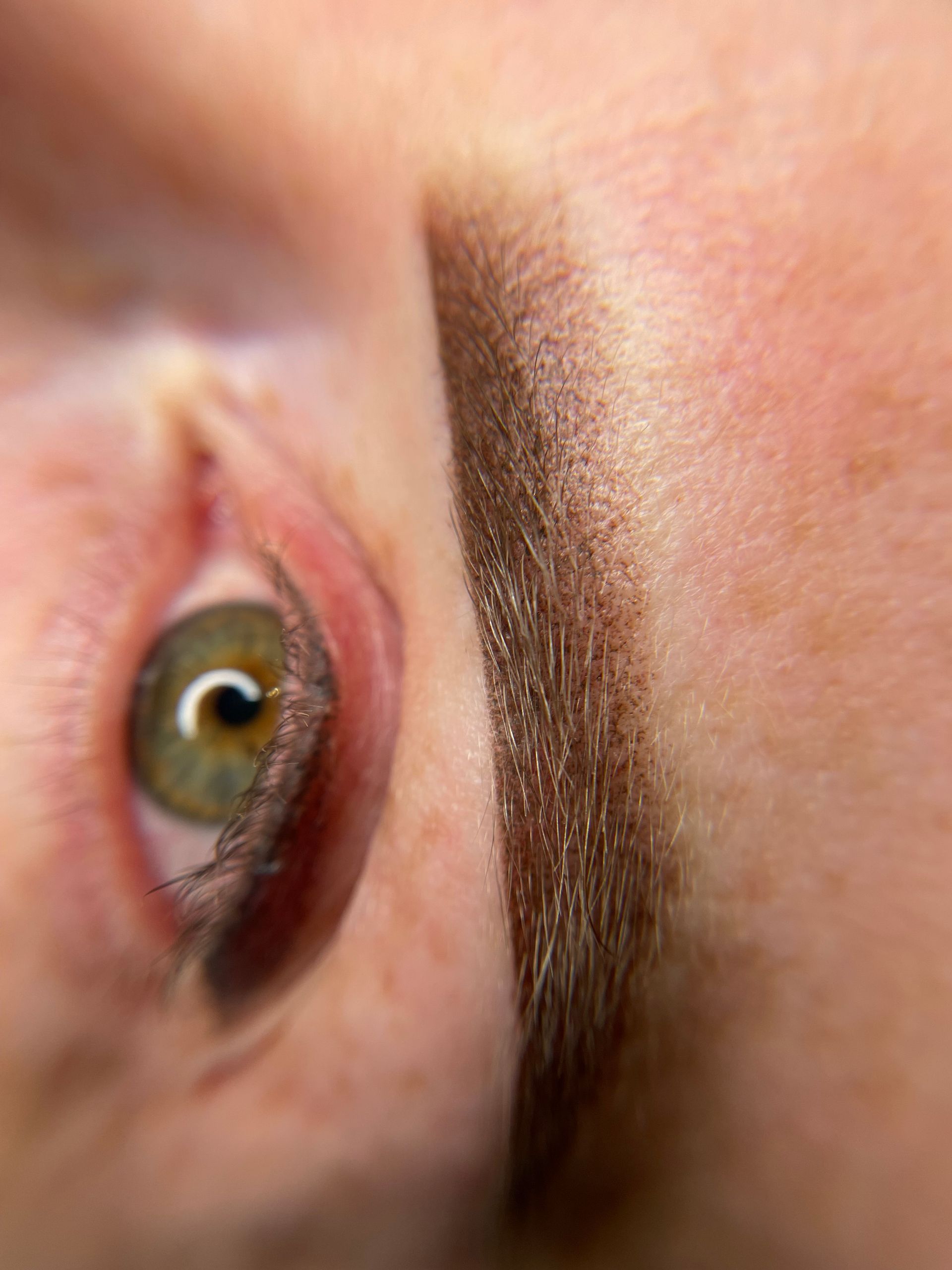 A close up of a woman 's eye and eyebrow.