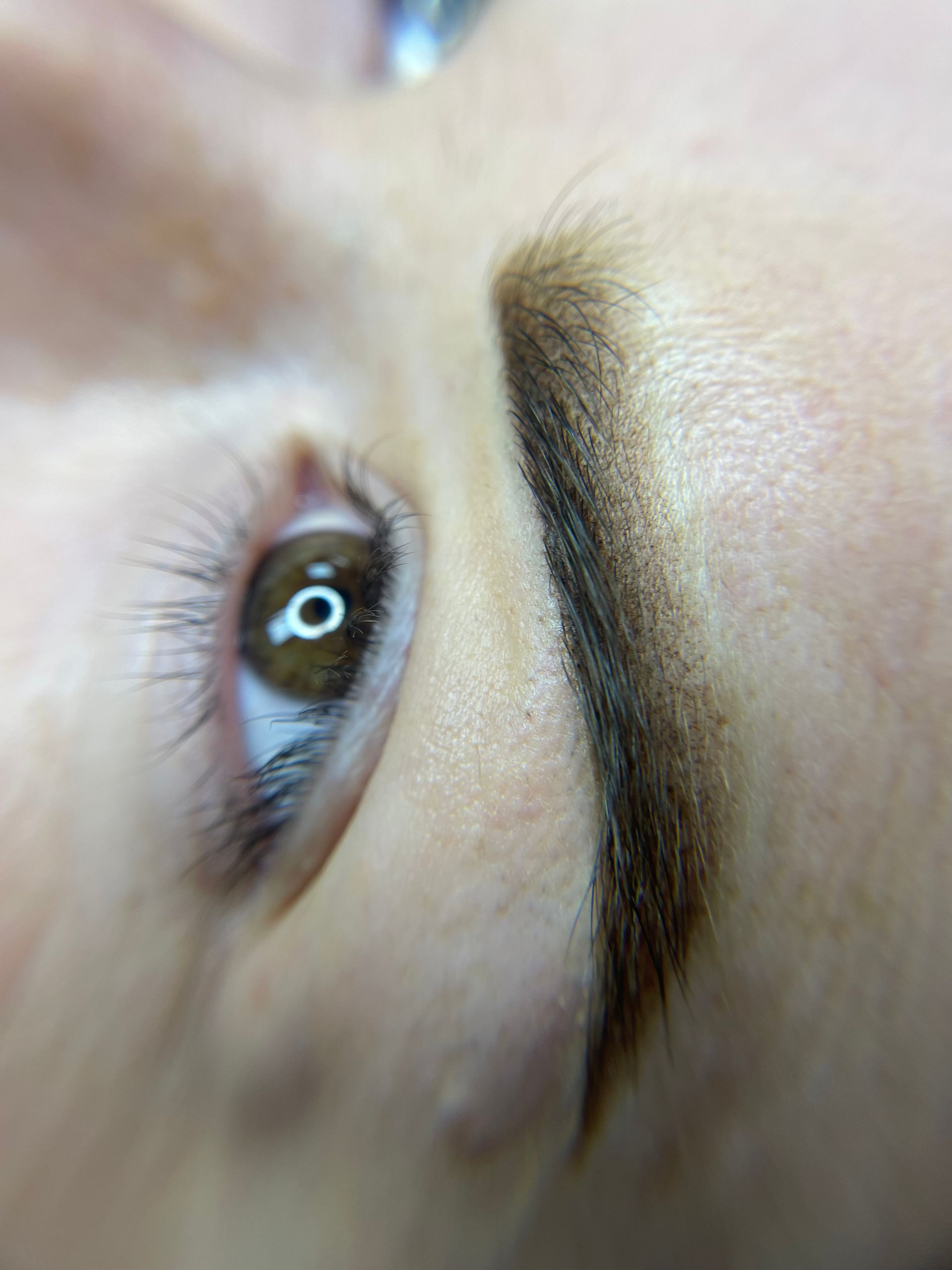A close up of a woman 's eye and eyebrow.