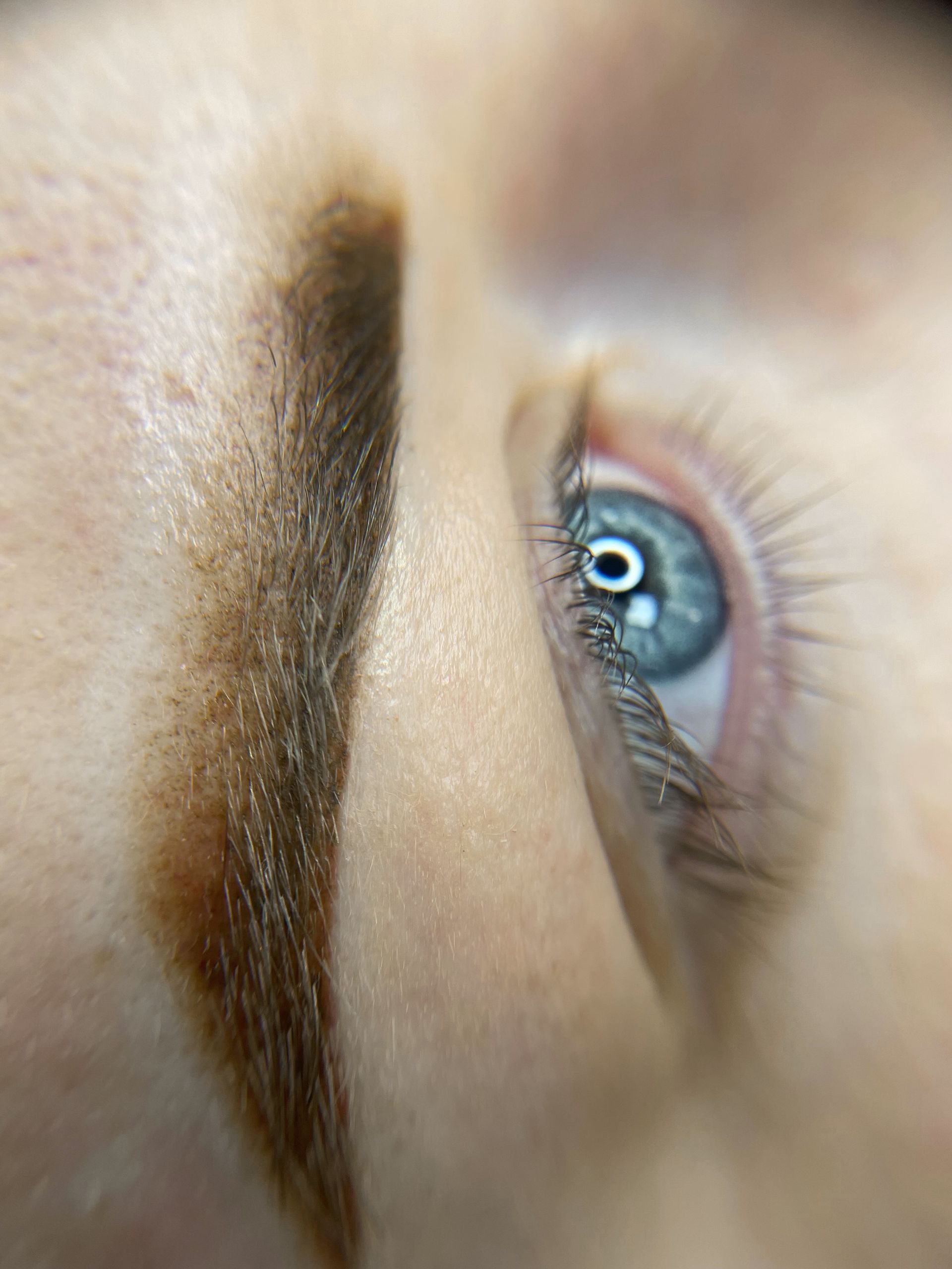 A close up of a woman 's eye and eyebrow.
