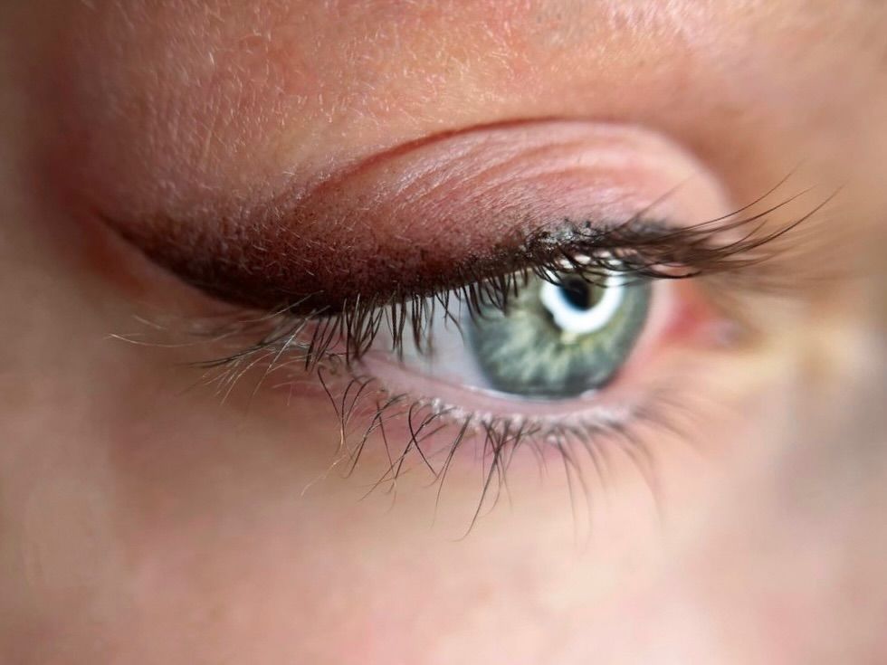 A black and white photo of a woman wearing glasses and a sweater.