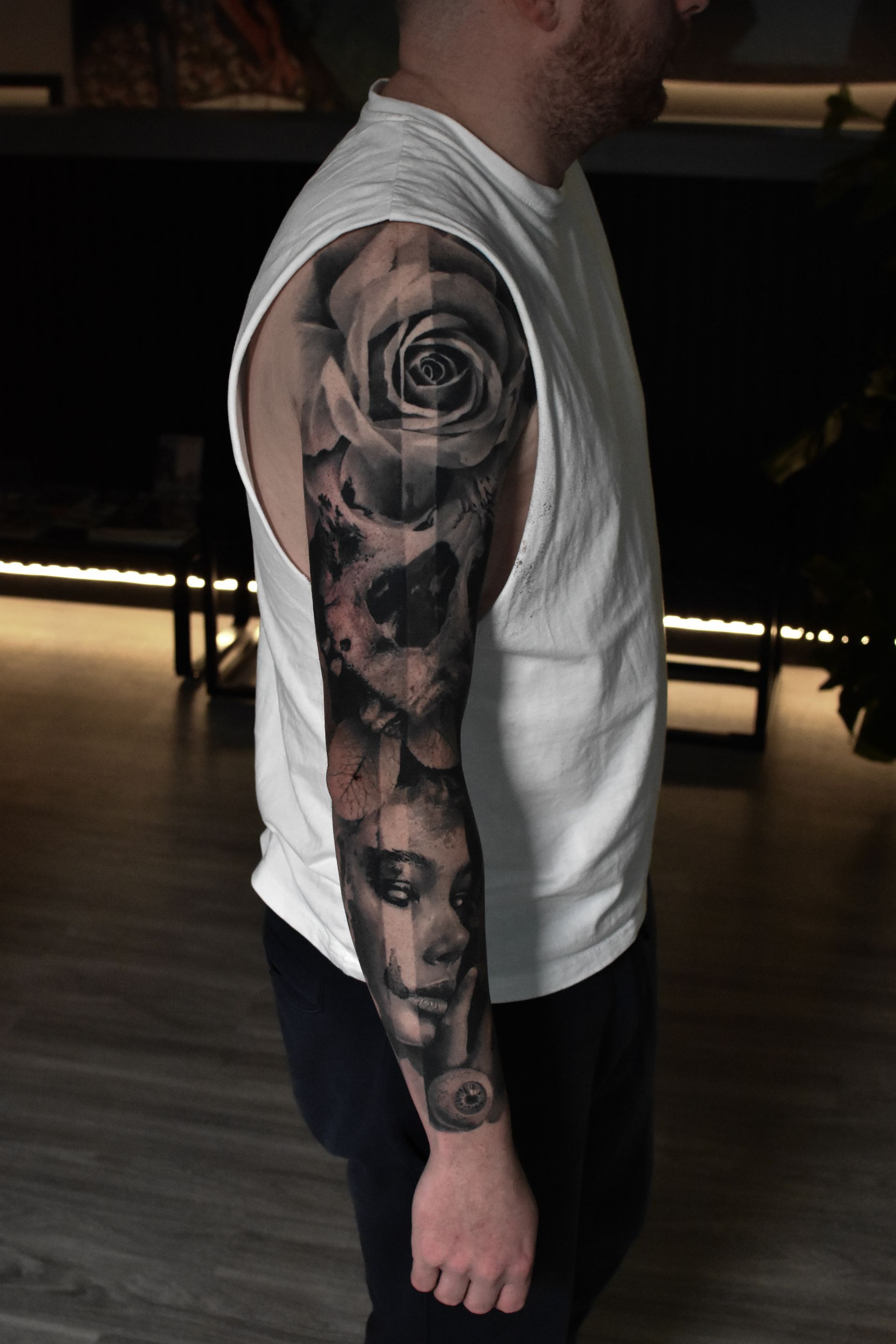 A man with a full sleeve tattoo on his arm