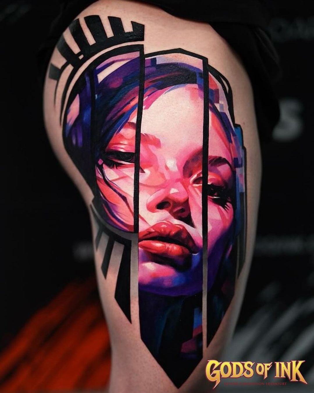 A bald man with a beard is wearing a black shirt.