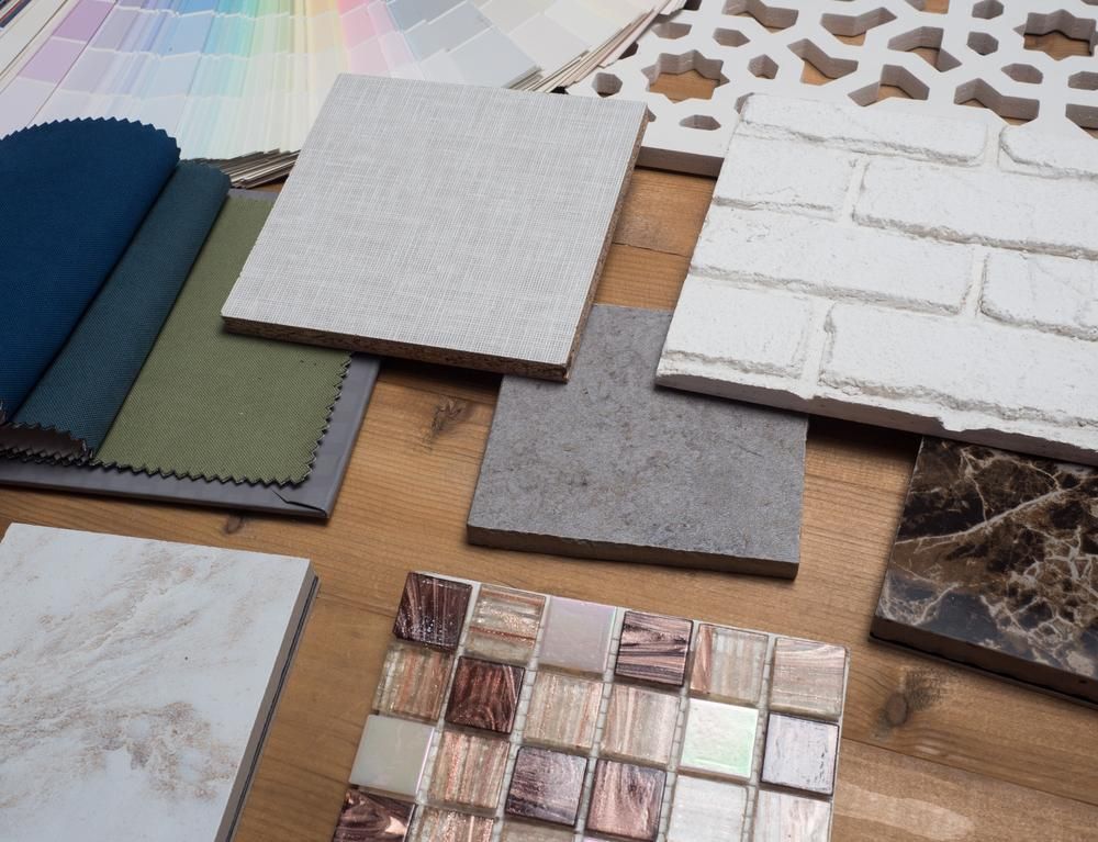 A Wooden Table Topped with a Variety of Tiles and Fabrics — D’Art Interiors in Eureka, NSW