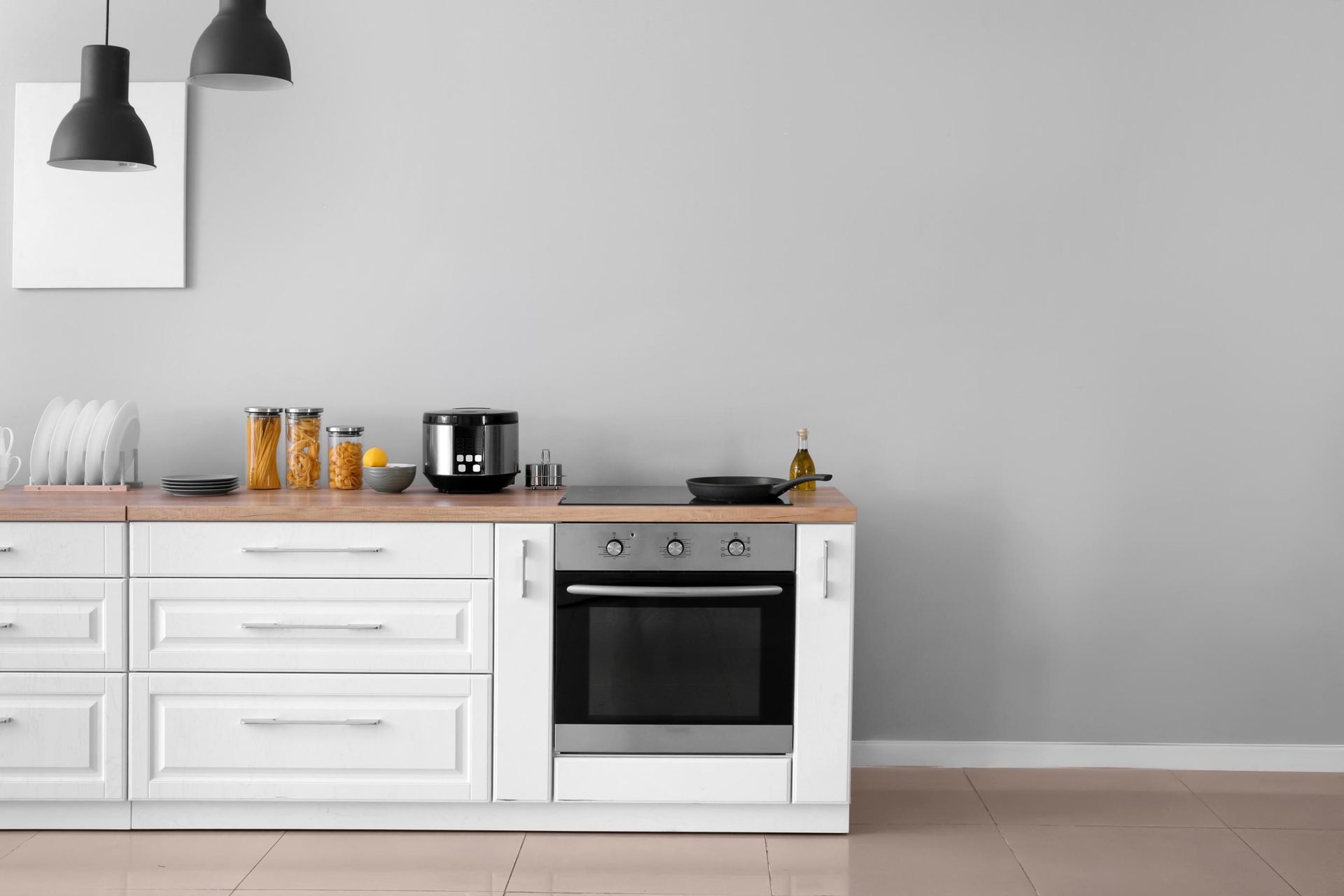 A Kitchen with White Cabinets, and Stove — D’Art Interiors in Byron Bay, NSW