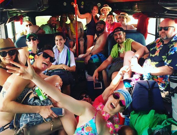 A group of people are posing for a picture in the back of a bus