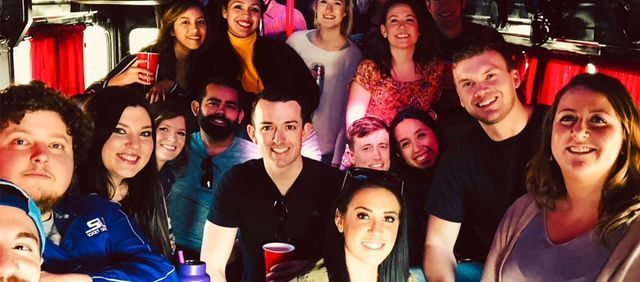 A group of people are posing for a picture in a bus.