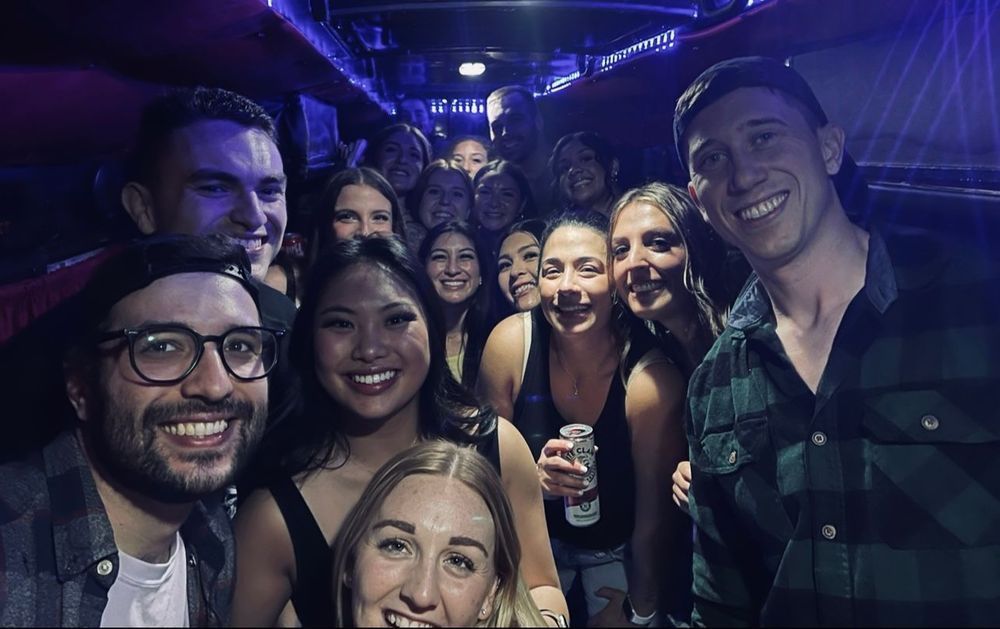 A group of people are posing for a picture in a dark room.