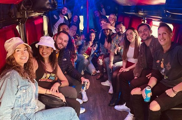 A group of people are sitting on a party rental bus.