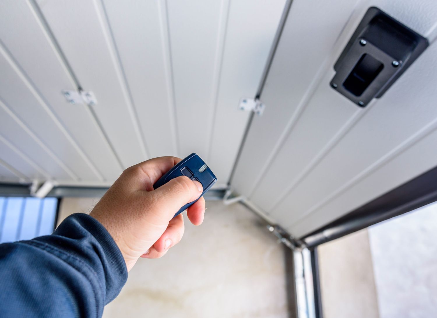 A Person Using the Garage Door Remote