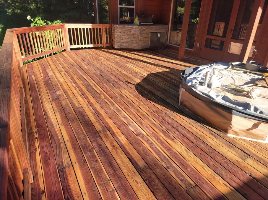A wooden deck with a hot tub on it