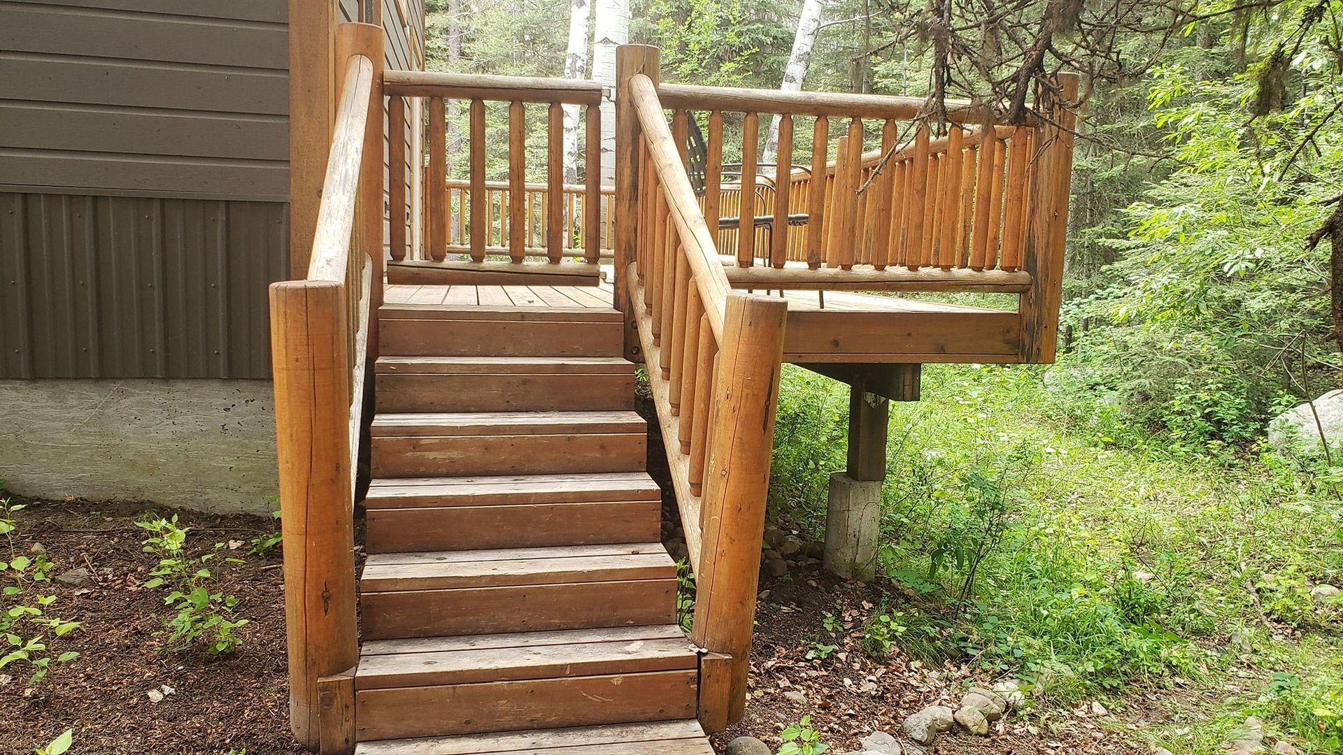 A wooden deck with stairs leading up to it