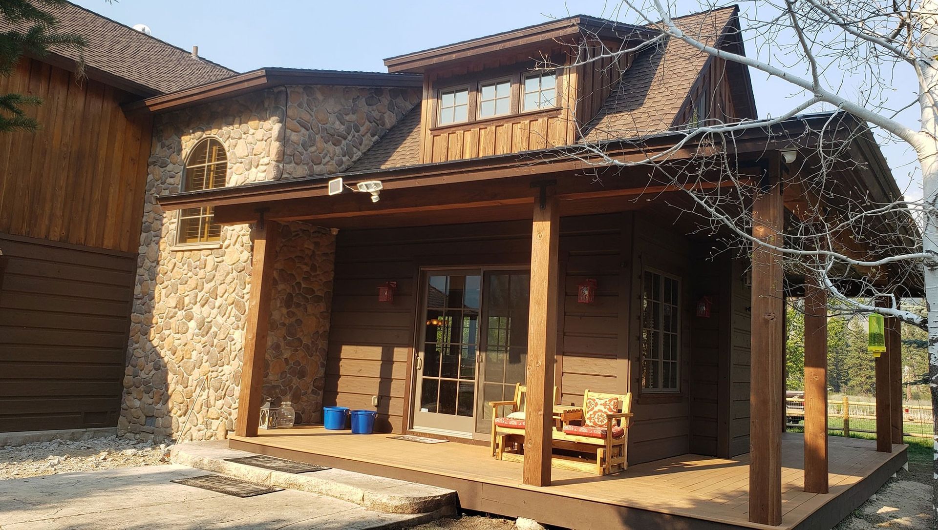 A house with a porch and chairs on it
