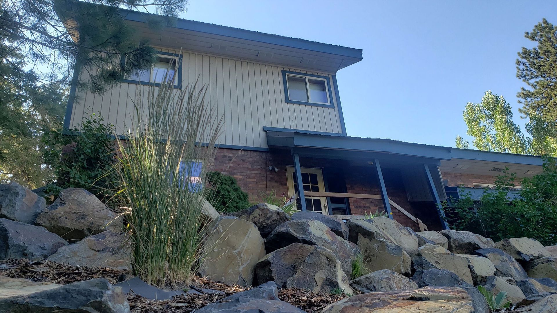 A house is sitting on top of a rocky hill.
