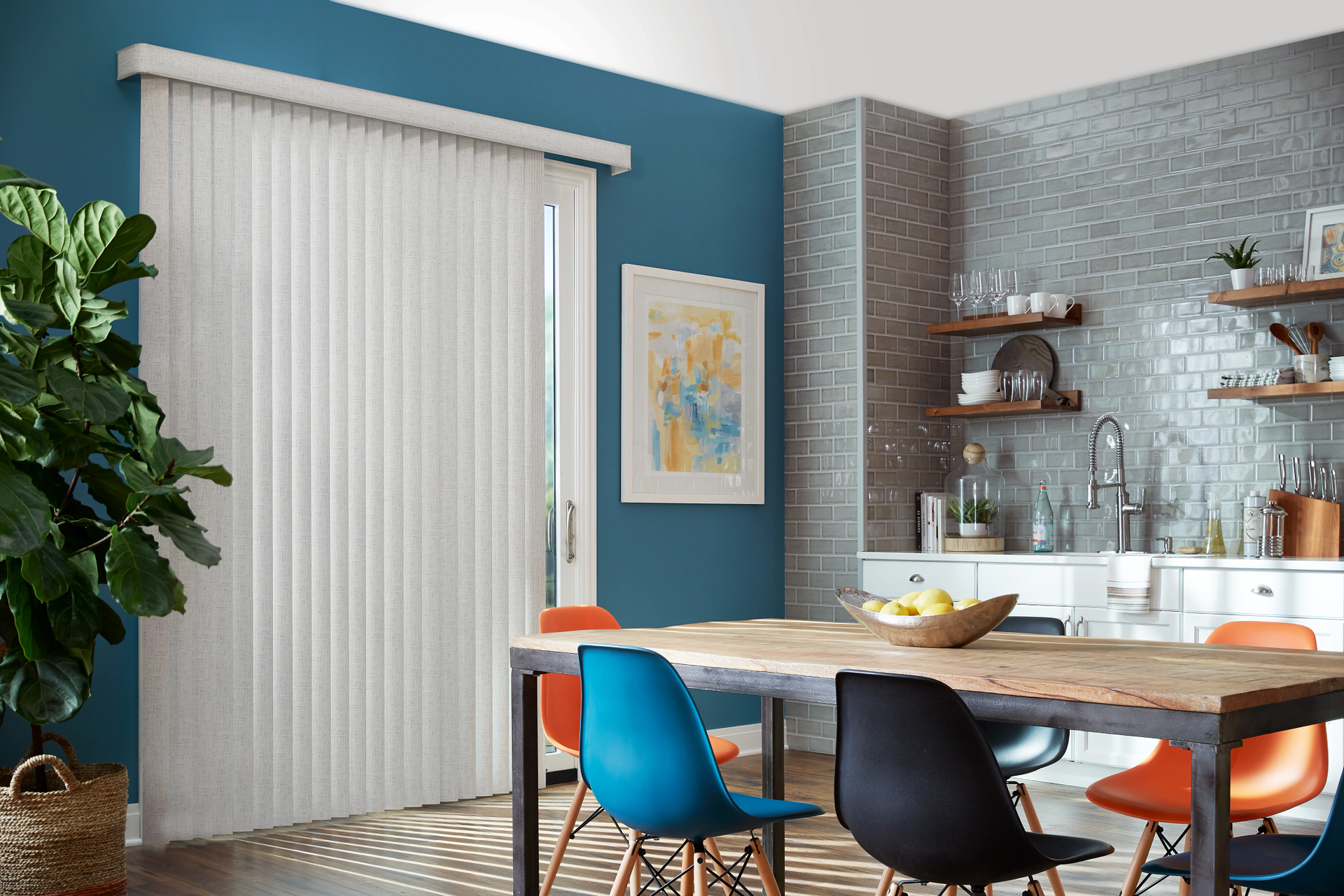 A dining room with a table and chairs and vertical blinds.