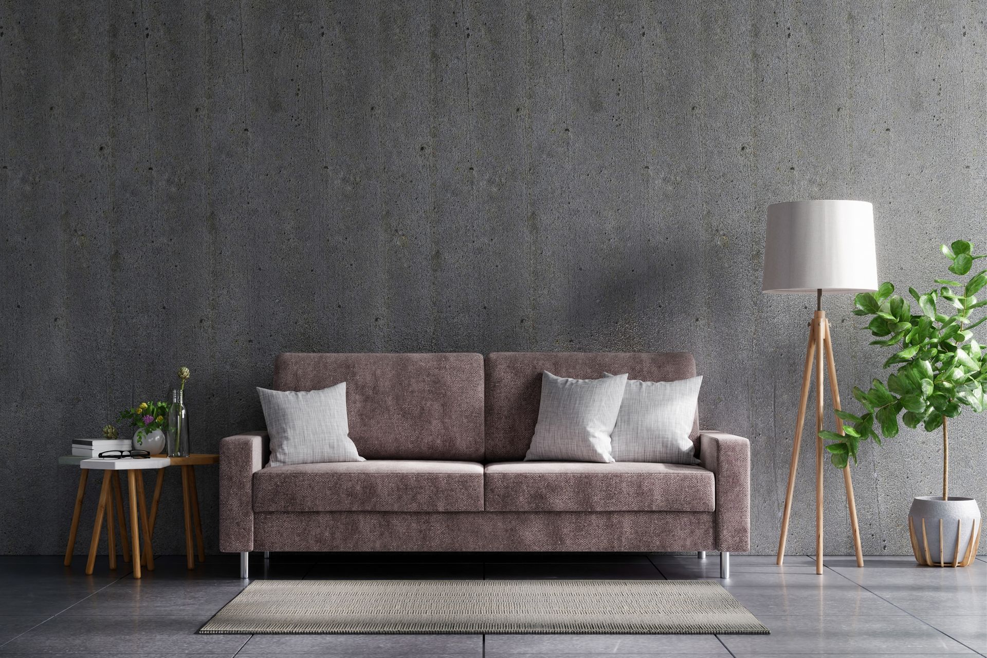 A living room with a couch and a lamp in front of a concrete wall.