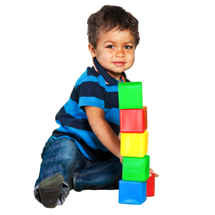 Young child building a tower of colorful blocks.