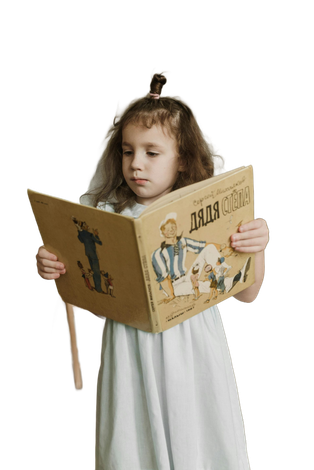 Girl in white dress intently reads a vintage book with illustration.