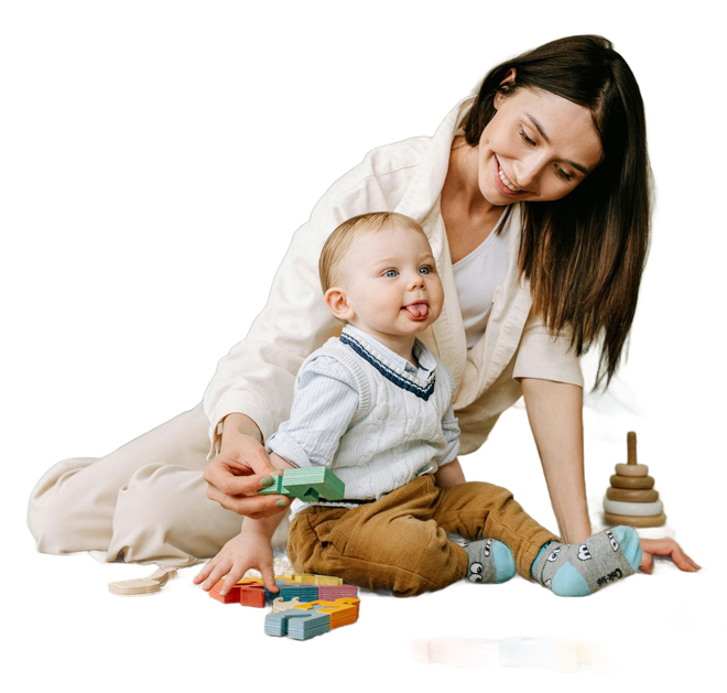 Woman and toddler playing with blocks; woman smiles, toddler sticks out tongue.