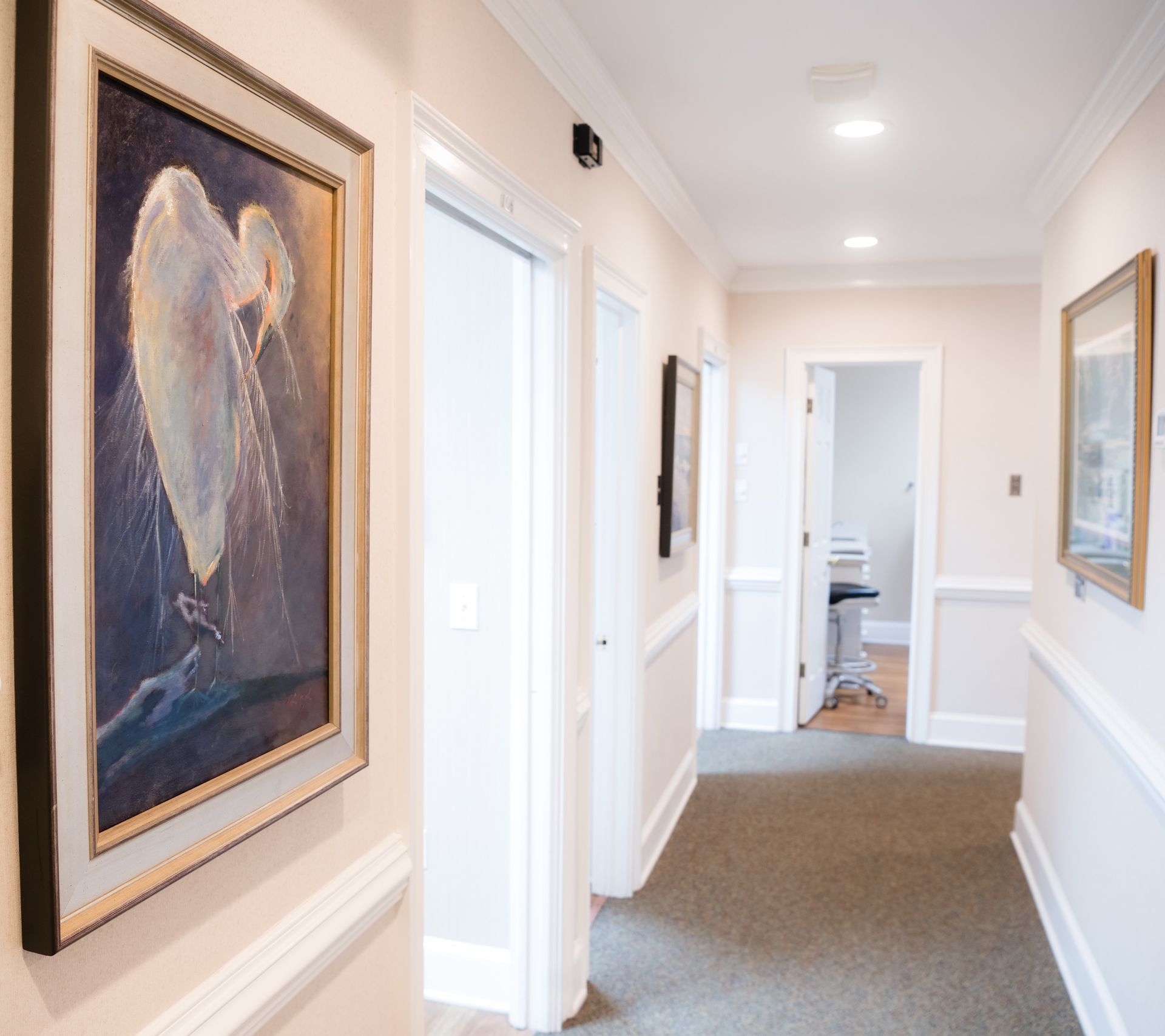 A hallway with a painting of an angel on the wall