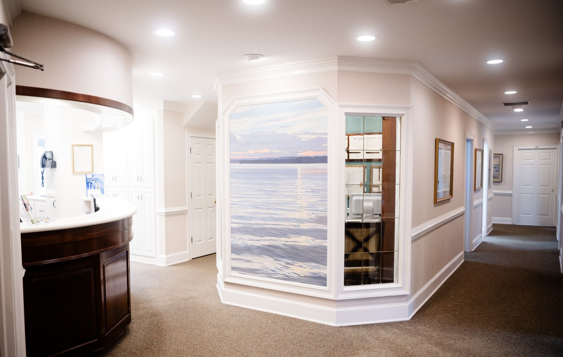 A hallway with a picture of the ocean on the wall