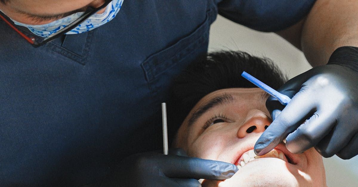 A man is getting his teeth examined by a dentist.