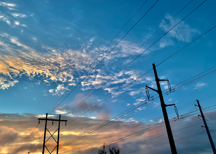 Image of power lines against a sunset sky