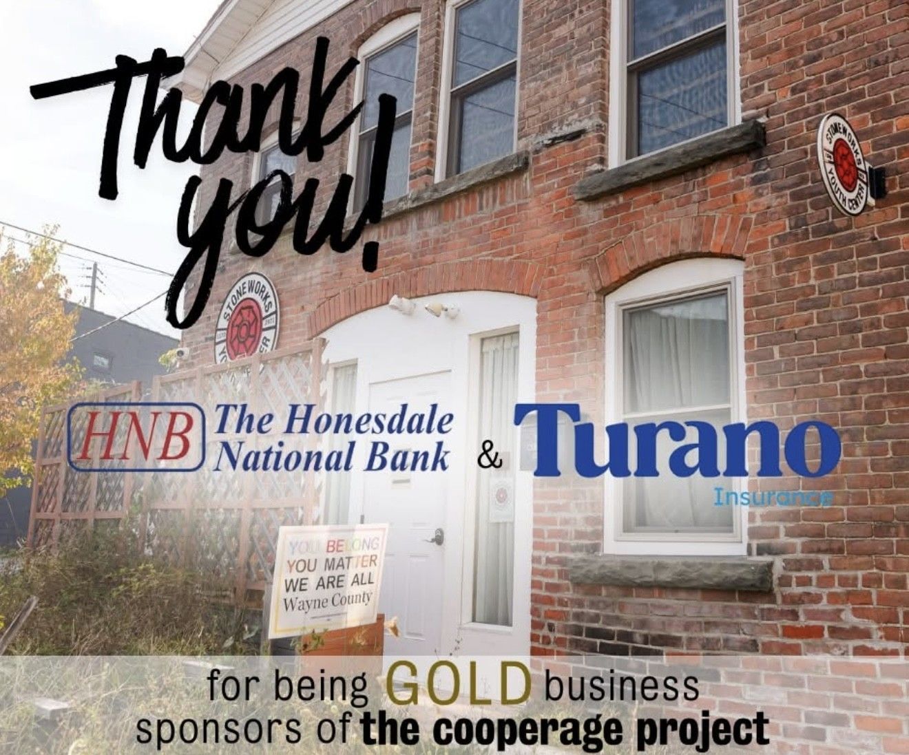 Thank-you sign on brick storefront thanking sponsors for the COLD business co-op project.