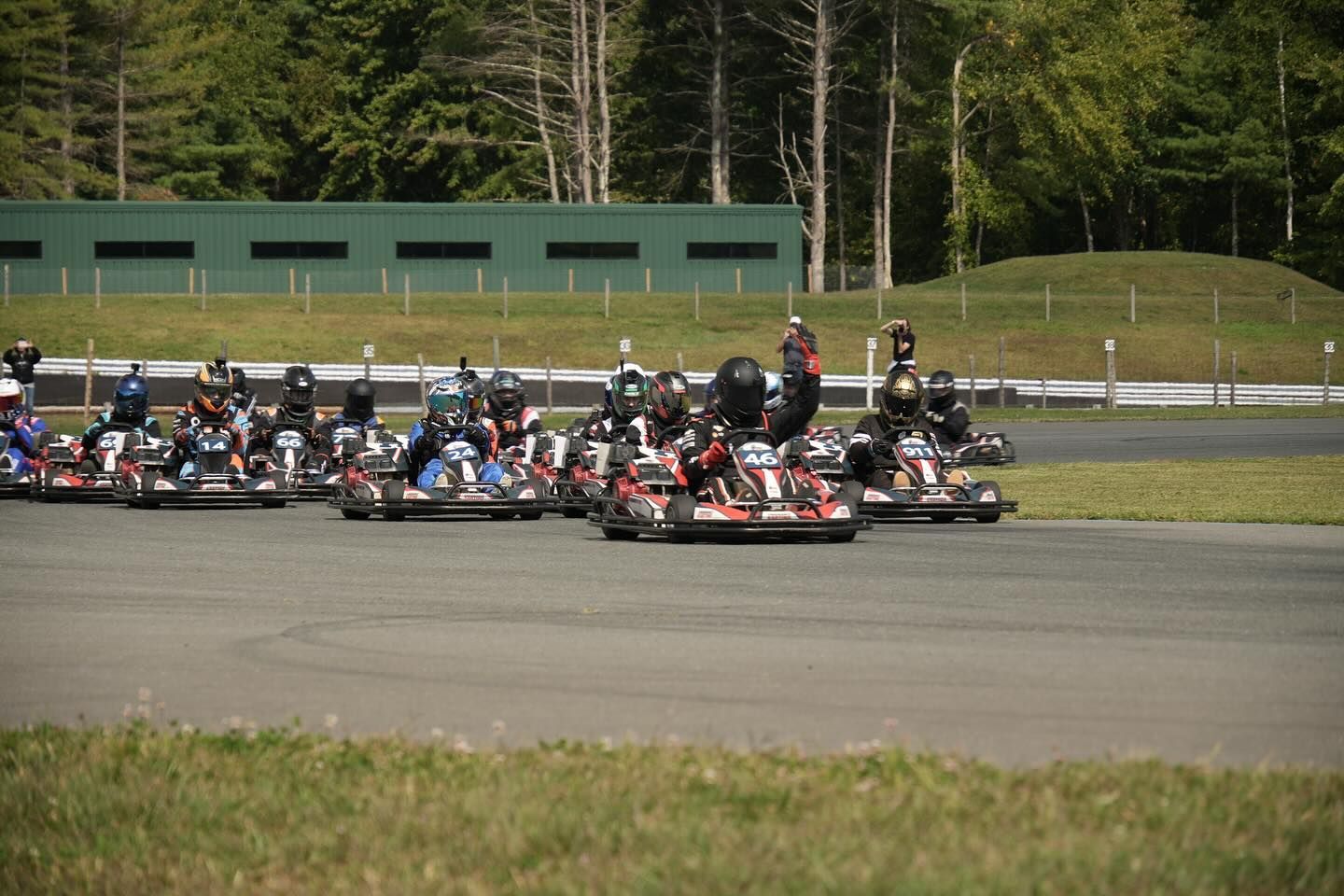 Go-karts lined up on a racetrack, ready to start a race.