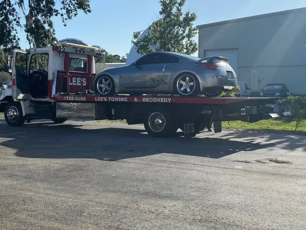 A car is sitting on top of a tow truck.