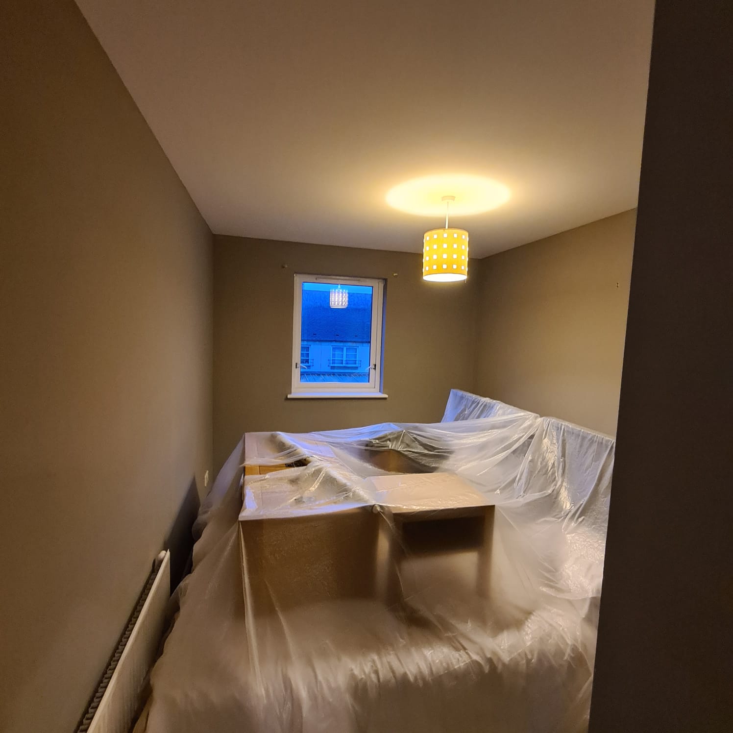 a box room painted in beige by painters and decorators Edinburgh